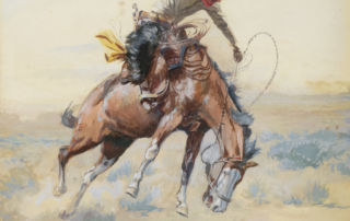 A cowboy rides a bucking horse.