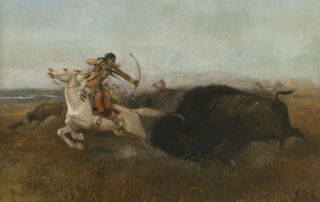 At full gallop, an indigenous American man on a white horse aims a bow and arrow at a running bison.