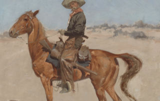 A cowboy sits atop a brown horse.