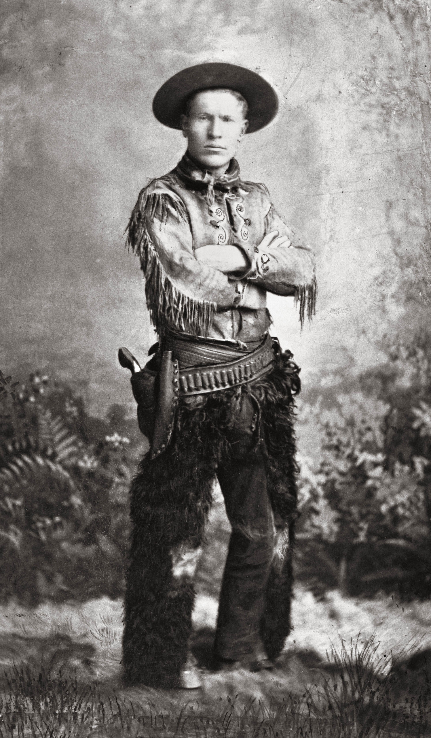 A young Charles Russell posing in cowboy gear