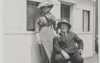 woman standing next to seated man on ship deck