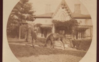 Remington with black horse in front of house in New Rochelle, New York