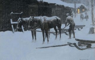 man unhitching sled from two horses in the snow at night