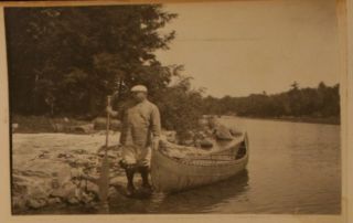 Remington pulling a canoe along a shore