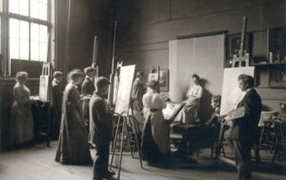 A group of young men and women painting at easels