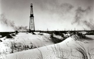 Keystone field with oil derricks in sand dunes