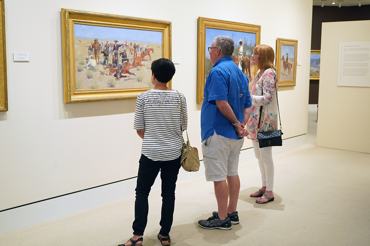 adults looking at a painting
