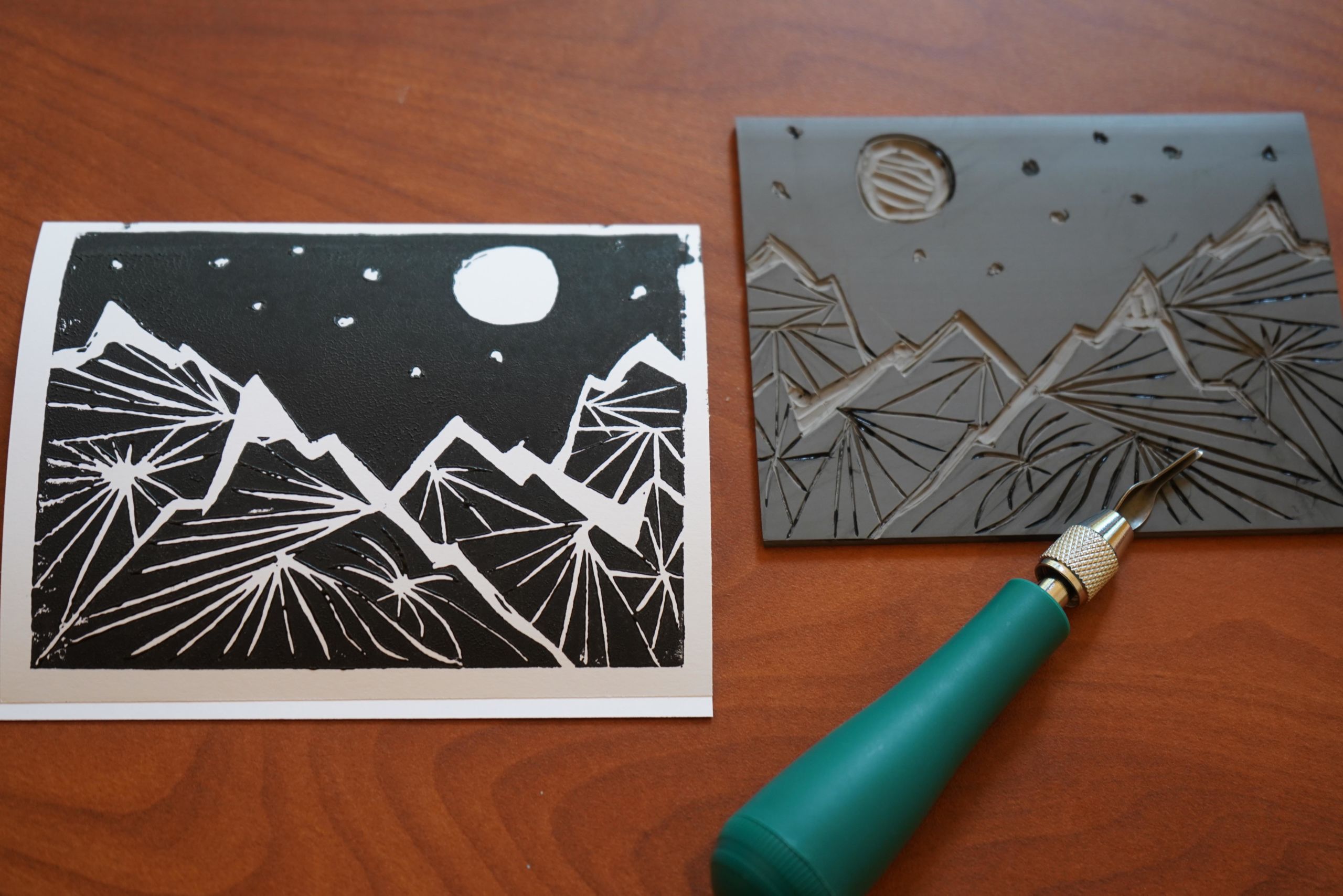linocut block next to print and carving tool