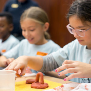 young girls working with clay