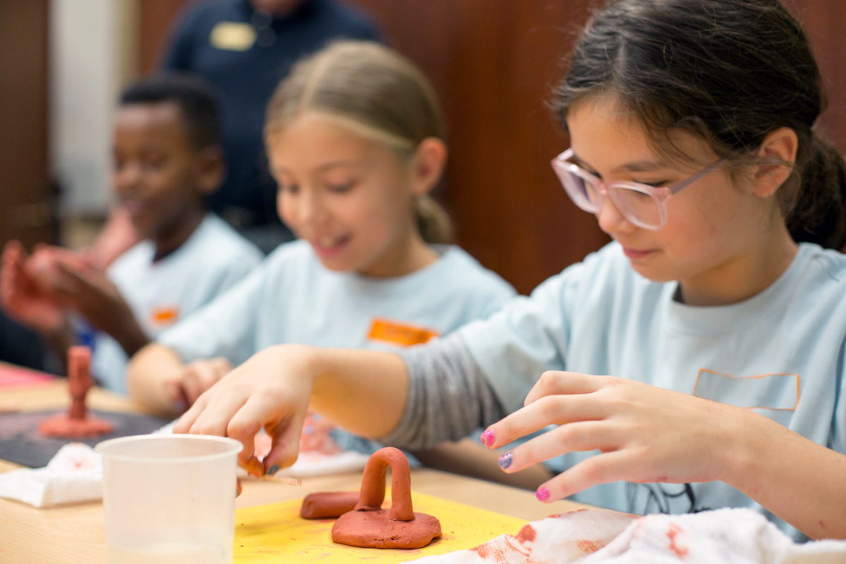 young girls working with clay