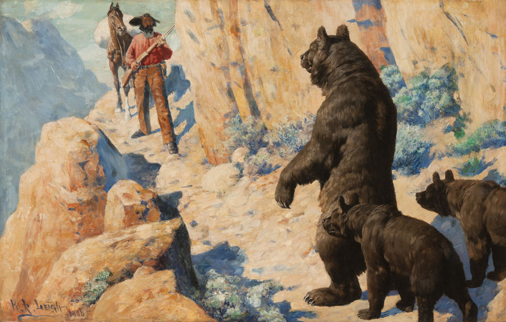 A man on a mountain path faces a standing bear with two cubs.