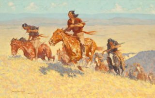 A group of indigenous American men holding rifles gallop up a hill on horseback.