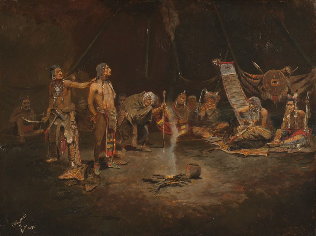 A group of Blackfoot Indians surround a captive Sioux man in a large enclosure.