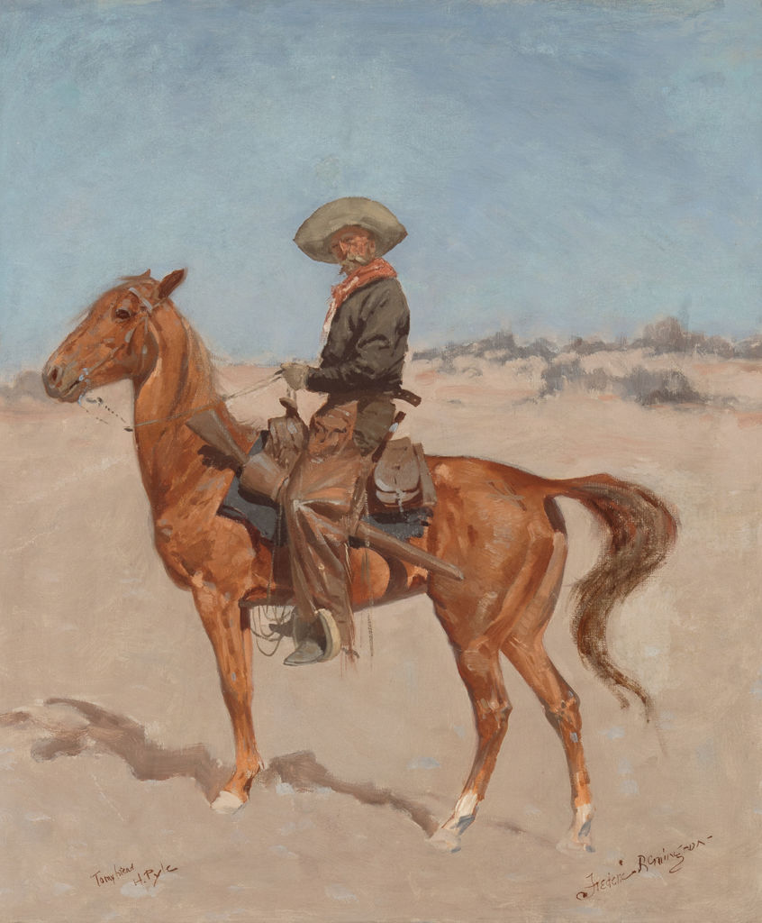 A cowboy sits atop a brown horse.
