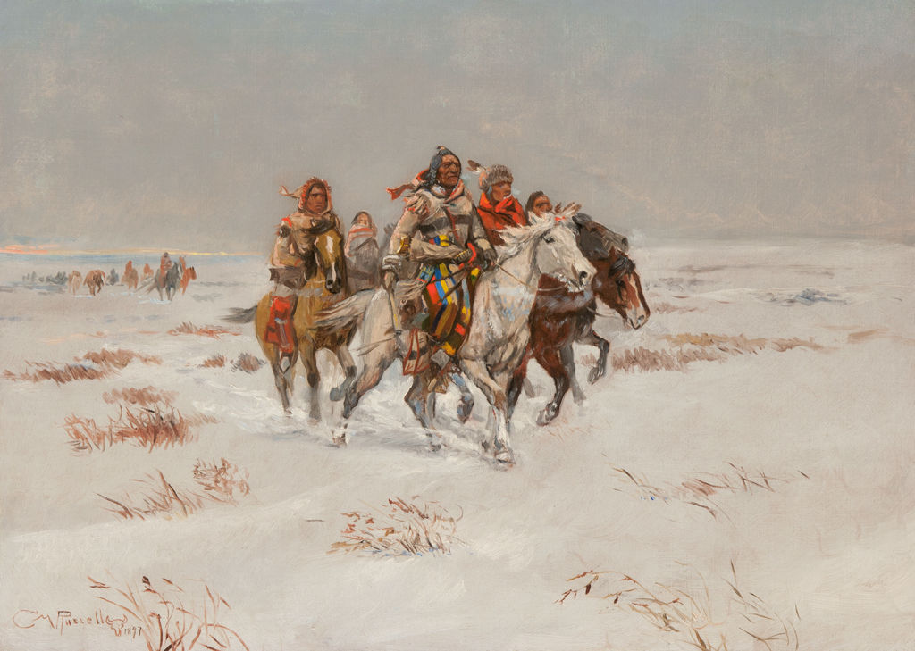 A group of indigenous Americans on horseback ride through a snowy landscape.