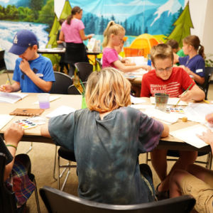 students painting at a table