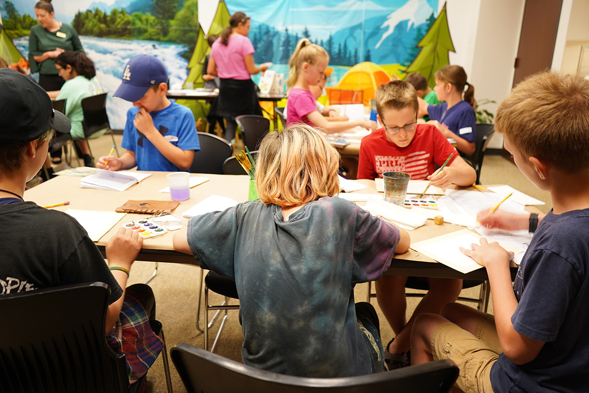 students painting at a table