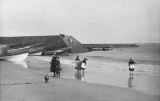 a group of young girls playing on seashore