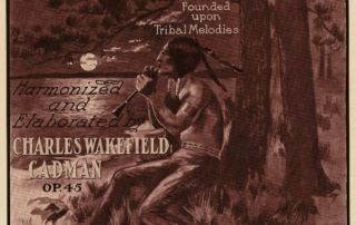 Sheet music cover with illustration of lone American Indian man playing a flute sitting under a tree in moonlight