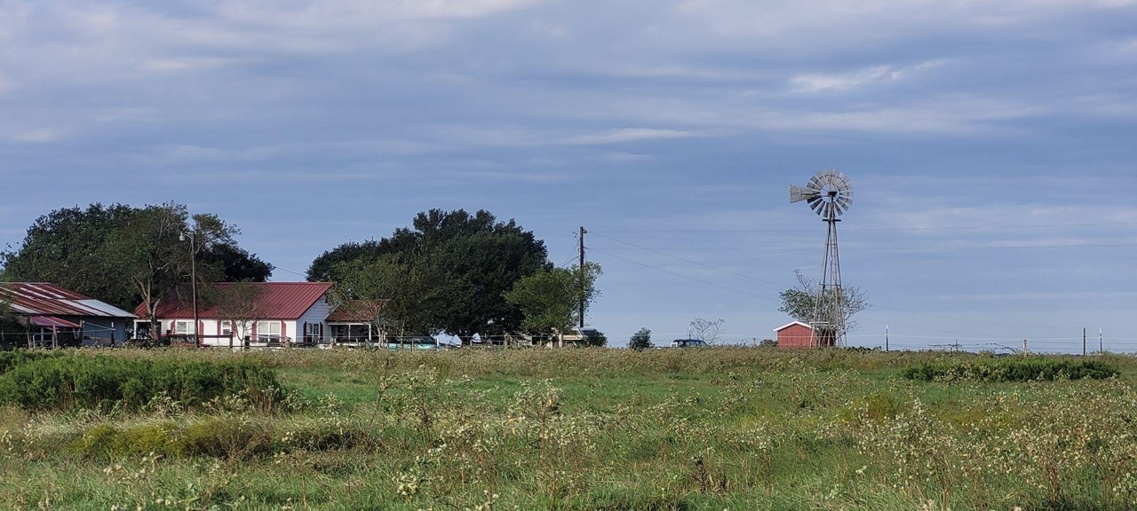 A house and barn on a prairie landscape