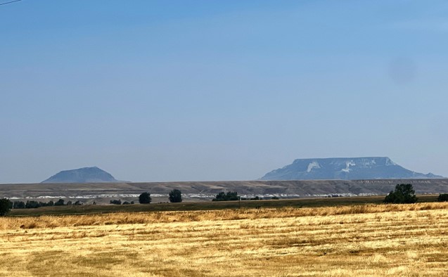 photograph of square butte and mountain top in distance