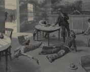 One man standing at a card table with the men shot on the ground around him