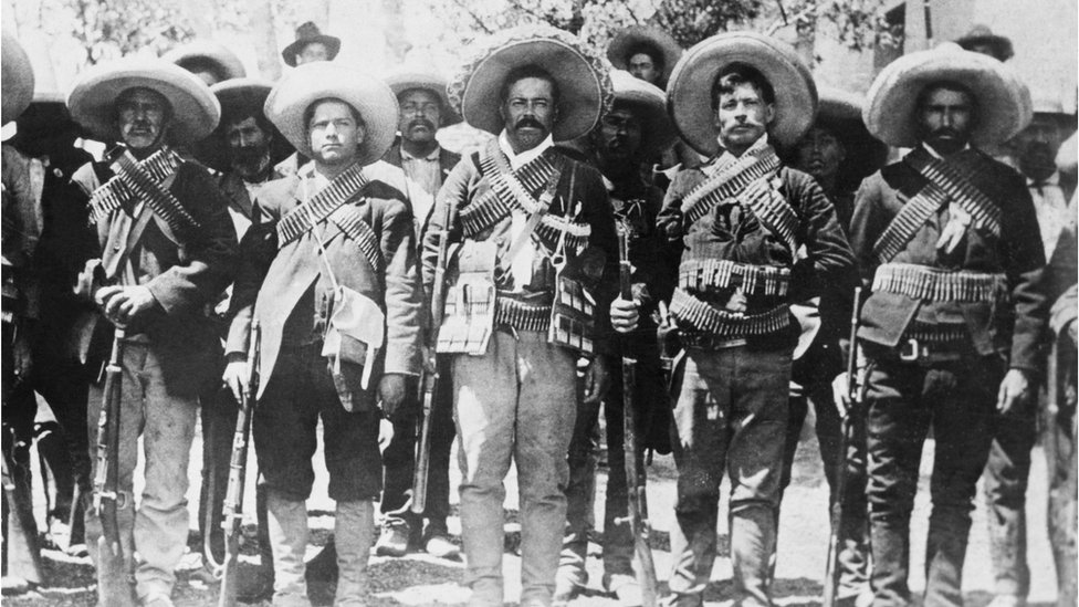 black and white photograph of a group of Mexican soldiers posing in a line for a photograph