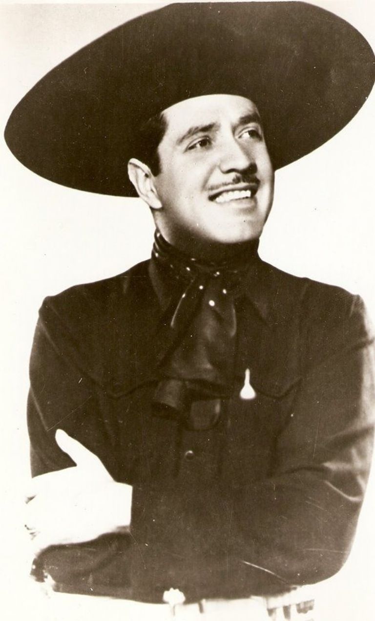 photograph of a man with a thin mustache wearing a large-brimmed hat