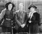 Two men and a woman posing for a photograph