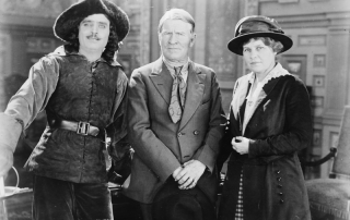 Two men and a woman posing for a photograph