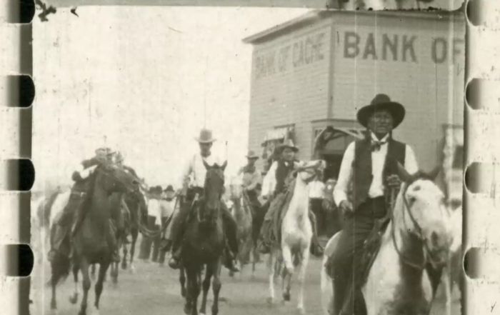 Group of men on horseback strolling down a town road